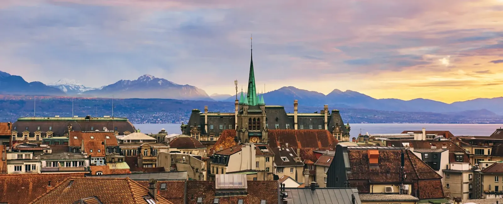 Tejados de Lausanne con el lago Lemán y los Alpes al atardecer